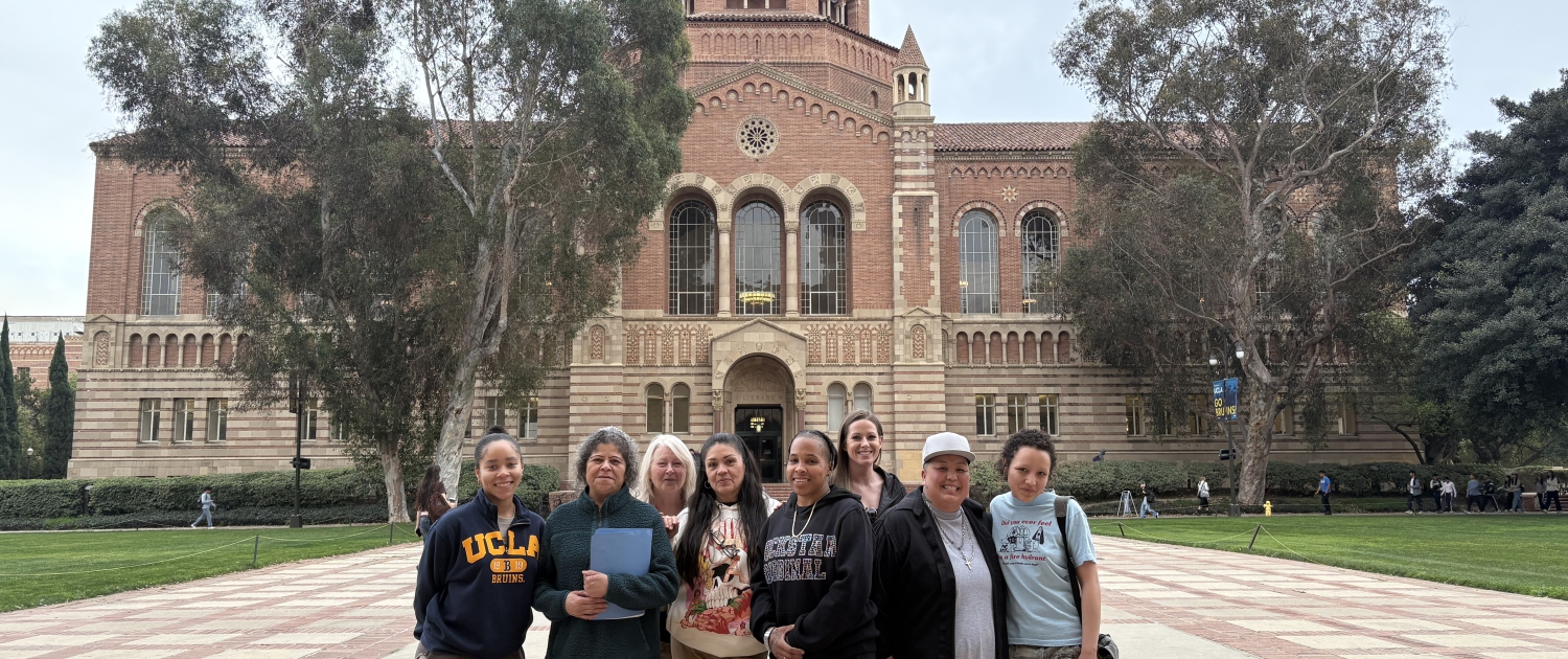 IMG_3313 A group of students stand in front of a brick building at UCLA's campus.