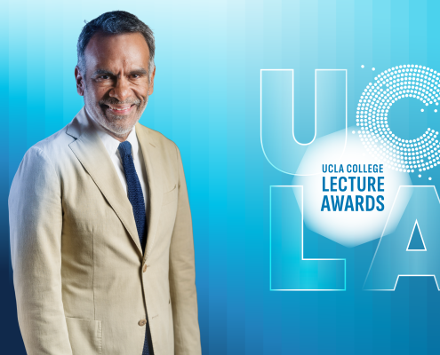 UCLA's eric Avila in a tan suite jacked with a white collar shirt and blue tie against a blue background that says UCLA College Lecture Awards.